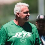 Rex Ryan in green Jets gear watching practice at New York Jets mandatory minicamp in Florham Park