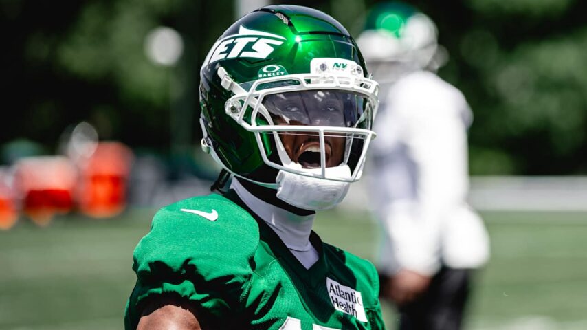 Jets wide receiver Adonai Mitchell practices in a green helmet and jersey