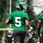 Garrett Wilson and Breece Hall walk together during New York Jets practice.