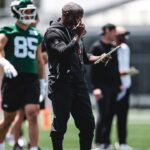 Aaron Glenn watches New York Jets practice during the 2026 offseason program.