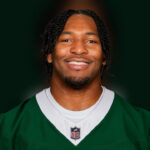 Kingsley Enagbare wearing a green New York Jets jersey.