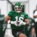 Kenyon Sadiq carries a football during New York Jets training camp