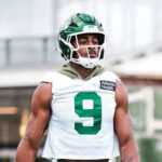 Will McDonald IV walks on the Jets practice field in his No. 9 jersey.
