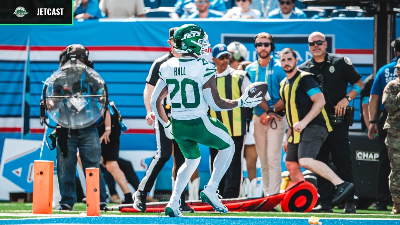 Breece Hall holding the football in the end zone against Tennessee, wearing Jets number 20.