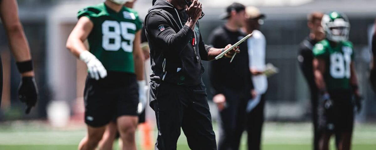Aaron Glenn watches New York Jets practice during the 2026 offseason program.